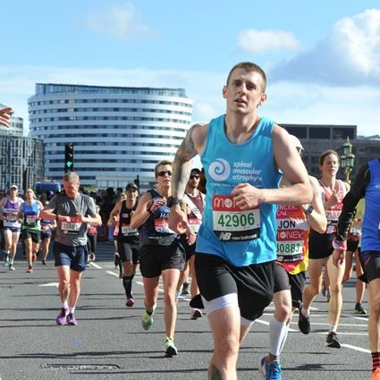 Man in SMA UK running vest taking part in London Marathon