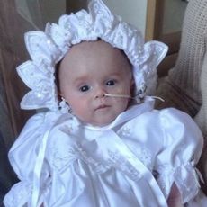 Baby in white Christening gown and bonnet