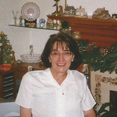 Female in white shirt and glasses seated