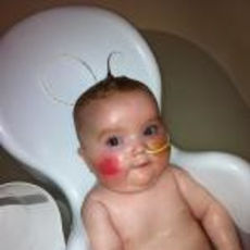 Baby in supported bath seat