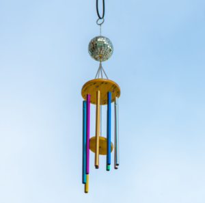 Image shows a multicoloured windchime against a blue sky.