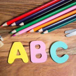 Image shows the letters A, B and C next to some coloured pencils.