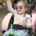 young girl in wheelchair with fun sunglasses at PIcnic 2023