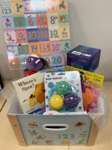 Toys and books for young children in box