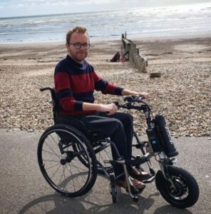 Image shows man in a wheelchair