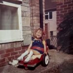 Clare when a young child in an early manual chair