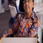 Vik  smiling in brightly coloured shirt