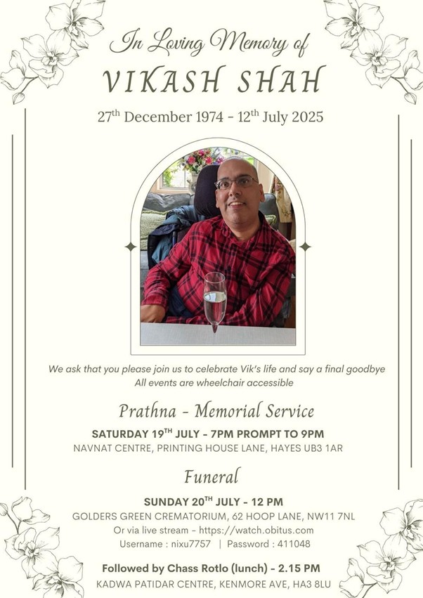 Vik memorial service with photo of him with a glass of champagne on his table